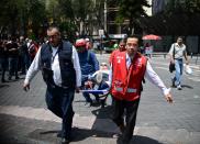 <p>A man is assisted in Mexico City after a real quake rattled the country on September 19, 2017 as an earthquake drill was being held in the capital. (Photo: Ronaldo Schemidt/AFP/Getty Images) </p>