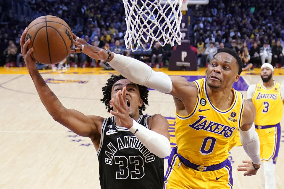 San Antonio Spurs guard Tre Jones, left, shoots as Los Angeles Lakers guard Russell Westbrook defends during the first half of an NBA basketball game Wednesday, Jan. 25, 2023, in Los Angeles. (AP Photo/Mark J. Terrill)