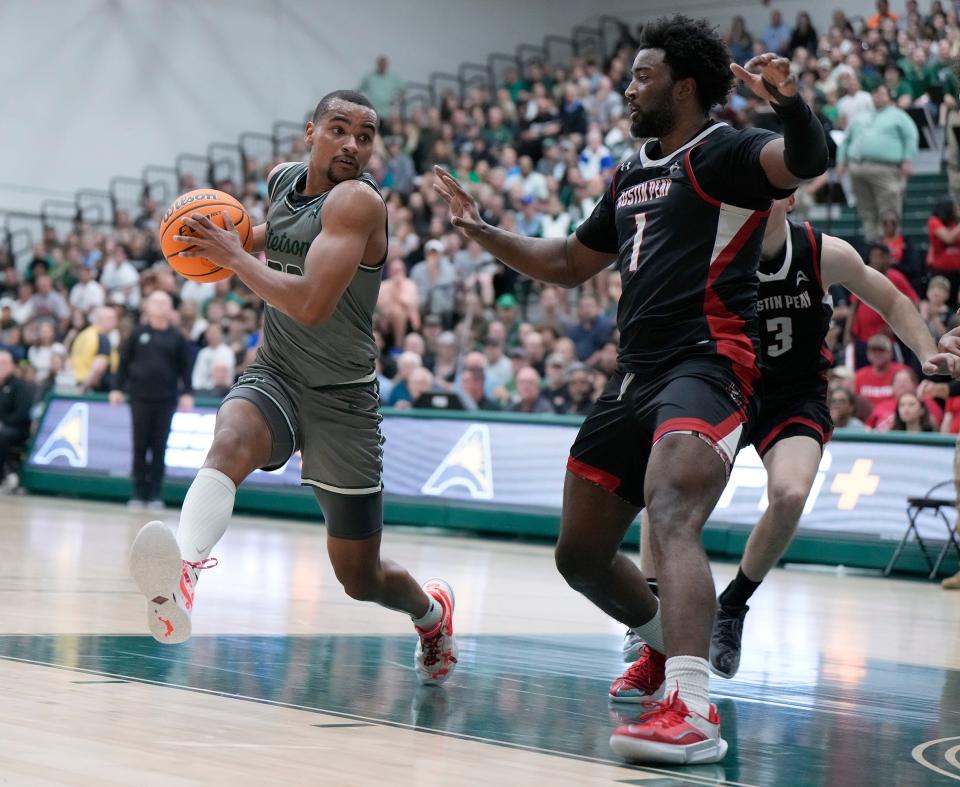 Stetson's Stephan Swenson looks to run around Austin Peay's Sai Witt during the ASUN Championship game at Edmunds Center in DeLand, Sunday, March 10, 2024.