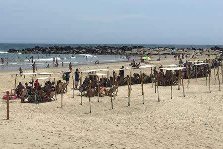 People enjoy a day on the beach in La Guaira, Venezuela May 17, 2018. REUTERS/Luc Cohen