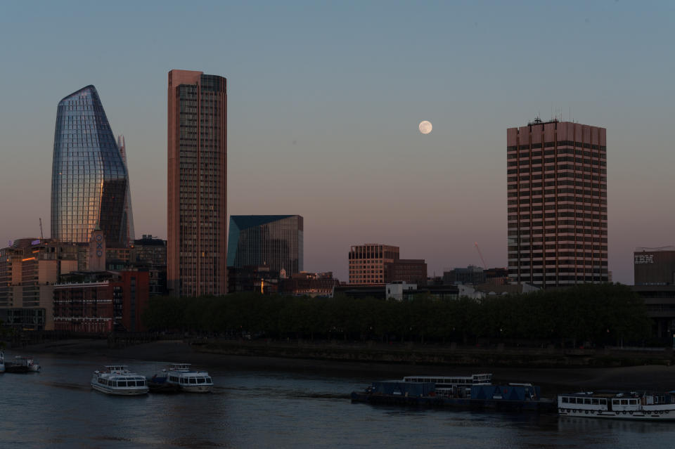 The super moon nestles between the skyscrapers of central London.