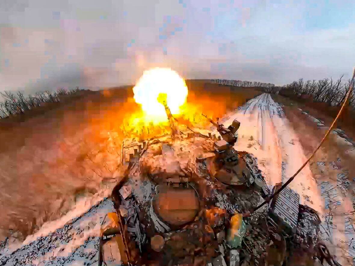 In this photo taken from video and released by Russian Defense Ministry Press Service on on Thursday, Feb. 8, 2024, a Russian tank fires a cannon at an undisclosed location in Ukraine. (Russian Defense Ministry Press Service via AP - image credit)