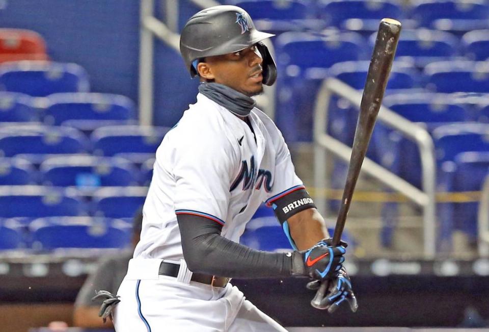 Miami Marlins center fielder Lewis Brinson (25) looks towards the infield after hitting the ball as the Miami Marlins host the New York Mets at Marlins Park in Miami on Wednesday, August 19, 2020.