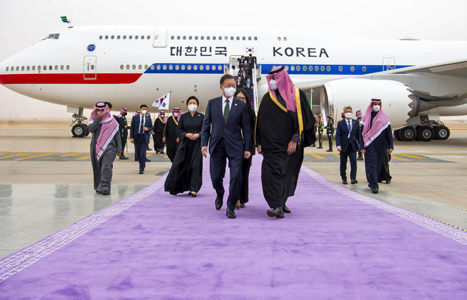 In this photo released by the Saudi Royal Palace, Saudi Crown Prince Mohammed bin Salman, right, receives South Korean President Moon Jae-in, at Riyadh international airport, Saudi Arabia, Tuesday, Jan. 18, 2022. (Bandar Aljaloud/Saudi Royal Palace via AP)