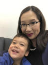 CORRECTS TO GEORGE WASHINGTON UNIVERSITY, NOT GEORGETOWN - This March 11, 2020 photo provided by Dr. Leana Wen shows her with her son in Baltimore. Wen, a George Washington University public health specialist, who is pregnant and due to give birth soon, says she wants answers as a physician and as a patient to her concerns over the coronavirus. “There is very limited information available,” she said. Her greatest fear is developing a COVID-19 infection or symptoms that would force her to be separated from her newborn for days or weeks. (Dr. Leana Wen via AP)