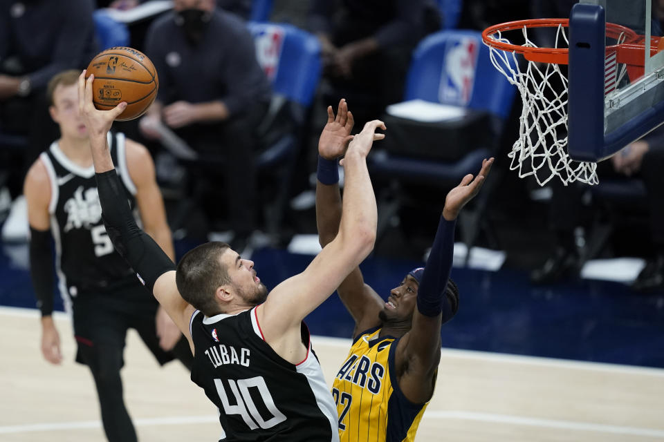 Los Angeles Clippers' Ivica Zubac (40) dunks over Indiana Pacers' Caris LeVert (22) during the first half of an NBA basketball game, Tuesday, April 13, 2021, in Indianapolis. (AP Photo/Darron Cummings)