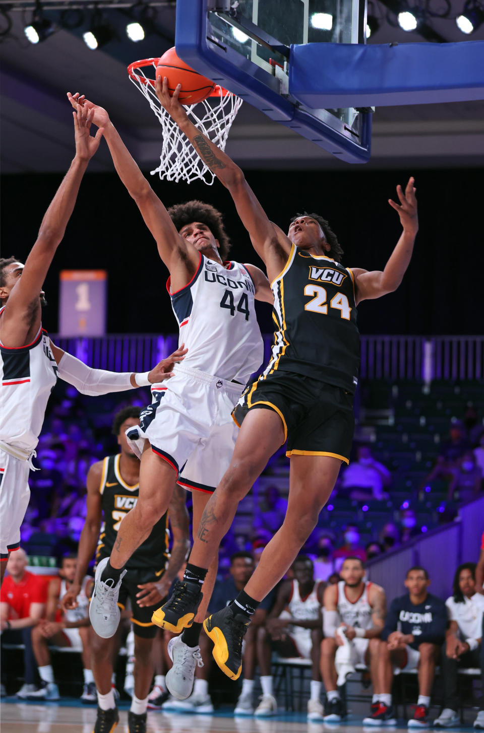 In this photo provided by Bahamas Visual Services, VCU guard Nick Kern (24) shoots as Connecticut Huskies guard Andre Jackson (44) defends during an NCAA college basketball game at Paradise Island, Bahamas, Friday, Nov. 26, 2021. (Craig Lenihan/Bahamas Visual Services via AP)