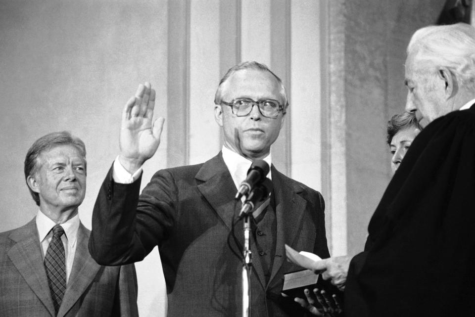 FILE - Benjamin Civiletti takes the Oath of Office for Attorney General during a ceremony at the Justice Department in Washington, Aug. 16, 1979, as President Jimmy Carter watches at left, and Chief Justice of the United States Warren Burger administers the oath, right. Civiletti, has died at age 87. The current attorney general, Merrick Garland, announced the death of his former boss and hailed what he called Civiletti's "skill, integrity and dedication.” The Baltimore Sun reports that Civiletti died Sunday evening, Oct. 16, 2022, of Parkinson’s at his home in Lutherville, Md. ((AP Photo)