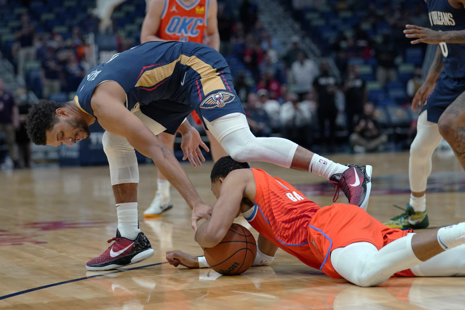 New Orleans Pelicans guard Josh Hart, above, battles for a loose ball with Oklahoma City Thunder forward Darius Bazley in the first half of an NBA basketball game in New Orleans, Wednesday, Nov. 10, 2021. (AP Photo/Gerald Herbert)
