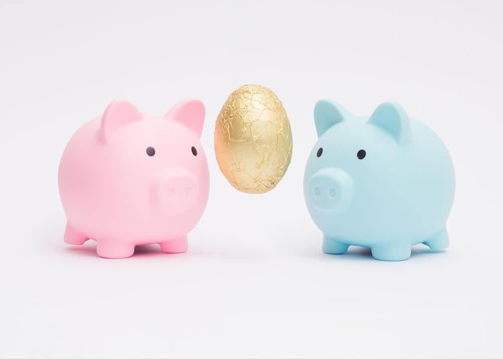 two piggy banks with golden egg symbolizing concept of combining two savings accounts