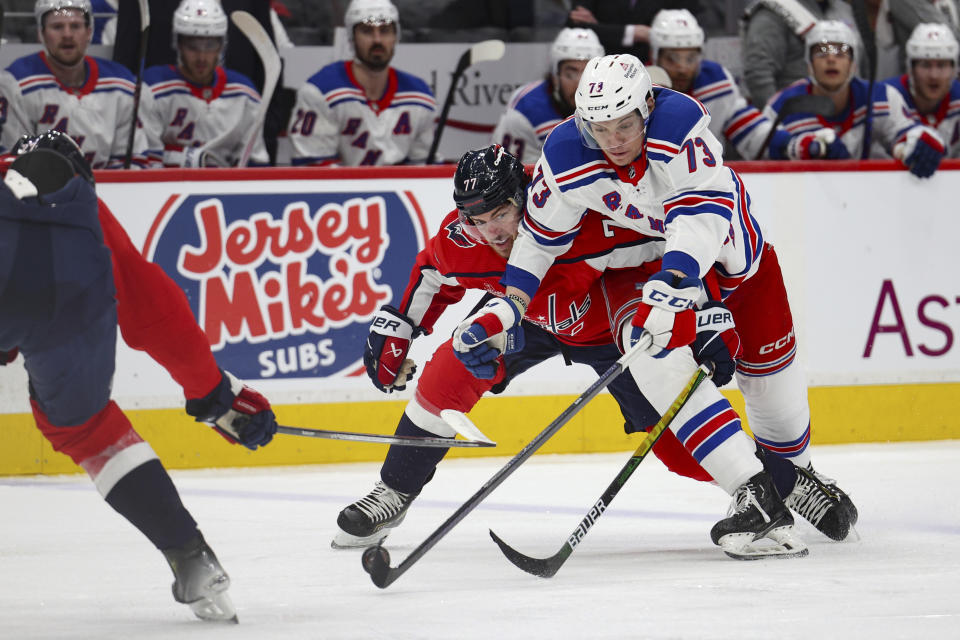 Washington Capitals right wing T.J. Oshie (77) collides with New York Rangers center Matt Rempe (73) during the second period in Game 3 of an NHL hockey Stanley Cup first-round playoff series Friday, April 26, 2024, in Washington. (AP Photo/Tom Brenner)