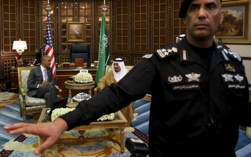 A guard ushers away photographers as Obama meets with King Salman at Erga Palace upon his arrival for a summit meeting in Riyadh, Saudi Arabia.