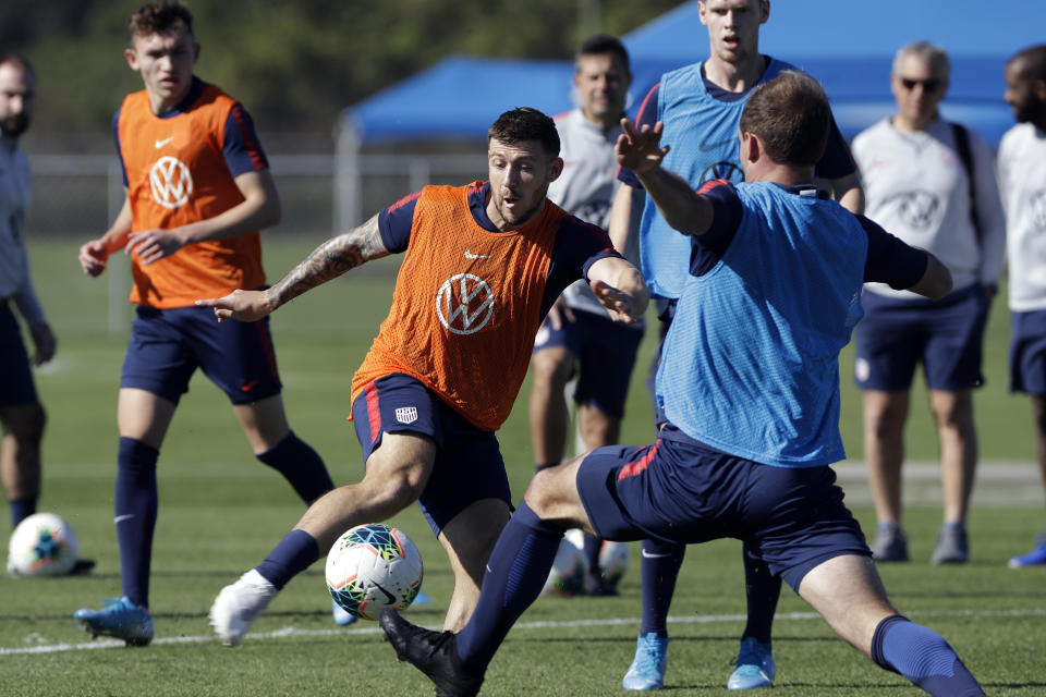 Paul Arriola, center, a forward on the U.S. Men's National Soccer team, kicks the ball during a scrimmage Wednesday, Jan. 8, 2020, in Bradenton, Fla. The team moved its training camp from Qatar to Florida in the wake of Iran's top military commander being killed during a U.S. airstrike in the Middle East. (AP Photo/Chris O'Meara)