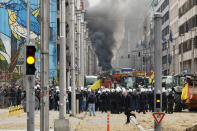 Police move in to clear a demonstration of farmers near the European Council building in Brussels, Tuesday, March 26, 2024. Dozens of tractors sealed off streets close to European Union headquarters where the 27 EU farm ministers are meeting to discuss the crisis in the sector which has led to months of demonstrations across the bloc. (AP Photo/Geert Vanden Wijngaert)