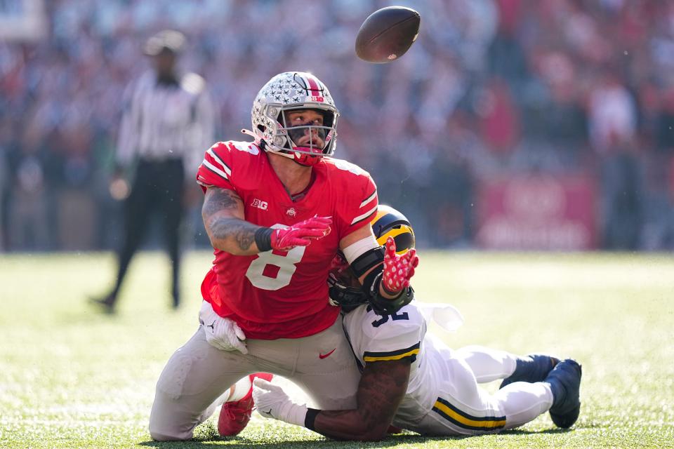 Ohio State tight end Cade Stover is unable to catch a pass while being defended by Michigan linebacker Jaylen Harrell.