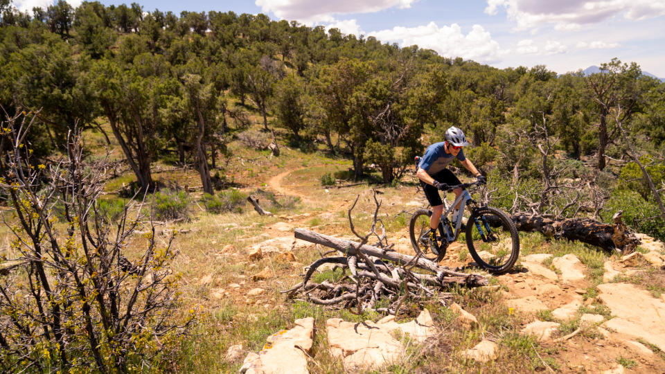 The Pivot Mach 4 SL being ridden up a rocky climb