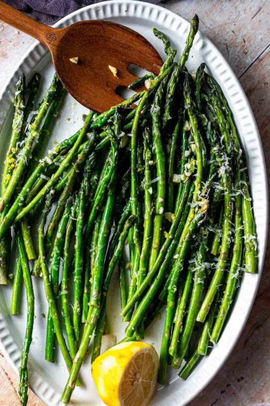 <p>Sweet Tea and Thyme</p><p>This garlic lemon asparagus recipe is a super easy side dish that your family will absolutely love! Fresh spring asparagus is sautéed with fresh lemon juice, zest, and garlic, then served with a sprinkle of delicious parmesan cheese. It's the best way to cook up that fresh spring produce.</p><p><strong>Get the recipe: <a href="https://www.sweetteaandthyme.com/lemon-garlic-sauteed-asparagus-2/" rel="nofollow noopener" target="_blank" data-ylk="slk:Easy Sautéed Lemon Garlic Asparagus;elm:context_link;itc:0;sec:content-canvas" class="link ">Easy Sautéed Lemon Garlic Asparagus</a></strong></p>