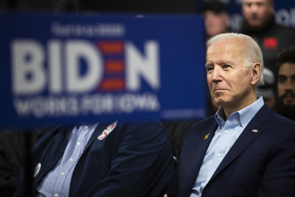 Democratic presidential candidate former Vice President Joe Biden listens to his introduction at a campaign event with the International Association of Bridge, Structural, and Ornamental Iron Workers, Sunday, Jan. 26, 2020, in Des Moines, Iowa. (AP Photo/Matt Rourke)