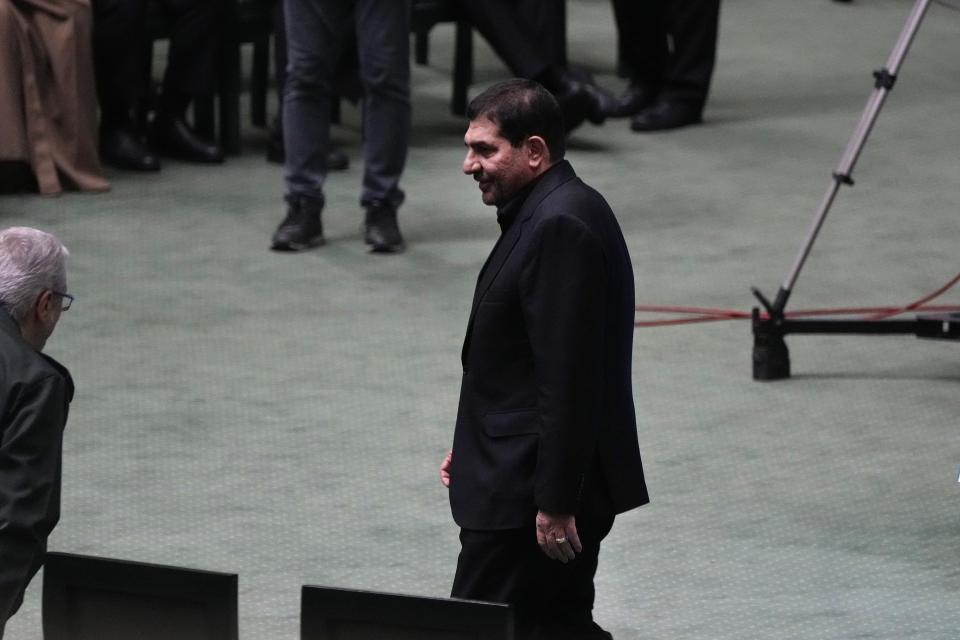 Iran's acting President Mohammad Mokhber walks through the parliament chamber during the opening ceremony of a new parliament term, in Tehran, Iran, Monday, May 27, 2024. Mokhber addressed the country's new parliament Monday in his first public speech since last week's helicopter crash that killed his predecessor and seven others. (AP Photo/Vahid Salemi)