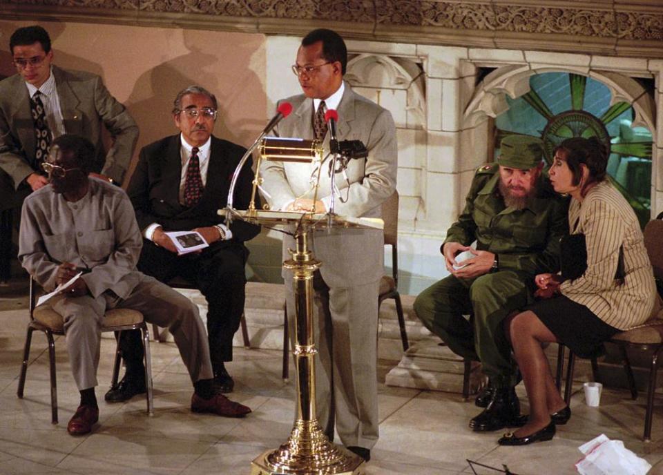 The Rev. Calvin Butts, center, addresses the congregation gathered to hear the speech by Cuban President Fidel Castro, right, while Juanita Vera, at far right, interprets for Castro inside Harlem’s Abyssinian Baptist Church, Sunday evening, Oct. 22, 1995 in New York. (AP Photo/Bebeto Matthews)