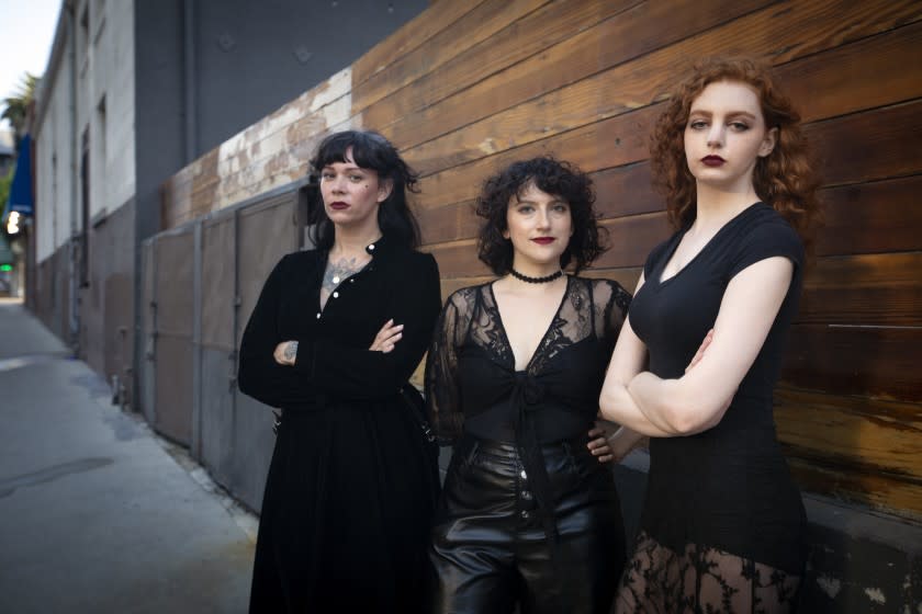 LOS ANGELES, CA - AUGUST 24: Portrait of Kate Morgan, former operations manager, 36, left, playwriter Annie Lesser, who wrote the scripts for the venue's performances, 31, middle, and Alison Waxman, 27, a member who states she was assaulted there. 27 at the Cloak & Dagger Monday, Aug. 24, 2020 in Los Angeles, CA. The portrait is of former employees and victims or harassment and abuse at the Cloak & Dagger nightclub in Hollywood, a secretive members-only goth venue run by a pair of prominent LA music producers. The photo was taken outside the venue where the club night was hosted. (Francine Orr / Los Angeles Times)