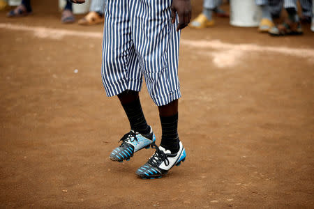 A prisoner warms up before a mock World Cup soccer match between Russia and Saudi Arabia, as part of a month-long soccer tournament involving eight prison teams at the Kamiti Maximum Prison, Kenya's largest prison facility, near Nairobi, Kenya, June 14, 2018. REUTERS/Baz Ratner