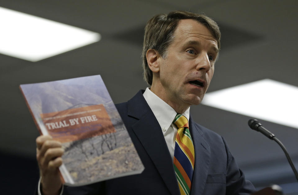 California Insurance Commissioner Dave Jones holds up a copy of a report during a news conference about the costs of recent wildfires Thursday, Sept. 6, 2018, in San Francisco. Jones released the first data on the total insurance claims reported for residential and commercial losses following the Carr and Mendocino Complex wildfires. Commissioner Jones also released updated data for the 2017 California wildfires and 2018 mudslides. (AP Photo/Eric Risberg)