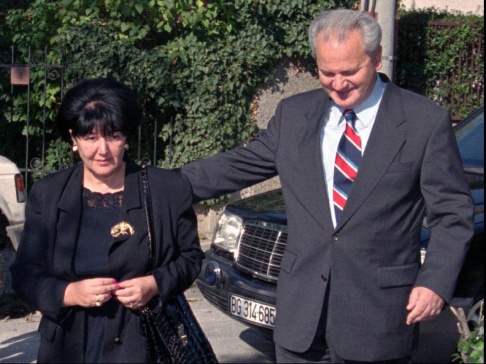 File - In this Sunday, Nov. 3, 1996 file photo, Serbian President Slobodan Milosevic, right, walks with his wife Mirjana Markovic towards the polling station. Serbia’s state television said that Mirjana Markovic, the widow of former strongman Slobodan Milosevic who was considered a power behind the scene behind his autocratic rule, has died in Russia on Saturday. She was 76, it was reported on Sunday, April 14, 2019. (AP Photo/ Darko Vojinovic, File)