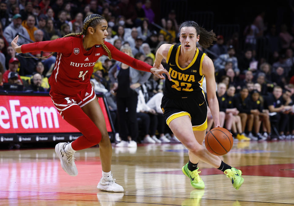 Iowa guard Caitlin Clark (22) drives to the basket against Rutgers guard Antonia Bates (4) during the first half of an NCAA college basketball game Friday, Jan. 5, 2024, in Piscataway, N.J. (AP Photo/Noah K. Murray)