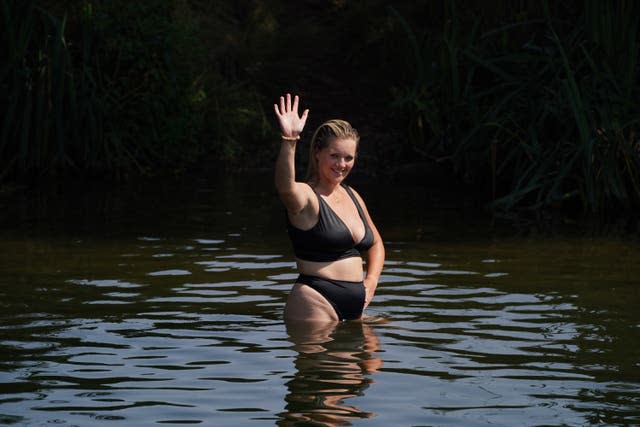 A woman keeps cool in the River Thames near Chertsey in Surrey