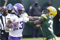 Minnesota Vikings' Dalvin Cook tries to get padt Green Bay Packers' Josh Jackson during the second half of an NFL football game Sunday, Nov. 1, 2020, in Green Bay, Wis. (AP Photo/Mike Roemer)