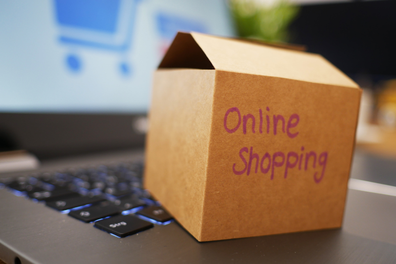 Box with Online Shopping Sitting on Keyboard