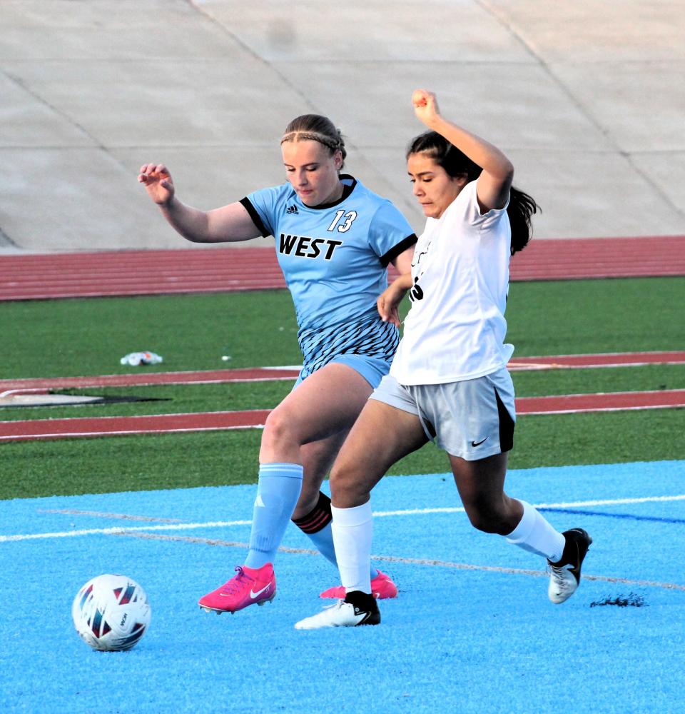 Pueblo South's Kyla Cruz battles to get the ball against Pueblo West's Jocelyn Thompson in a recent game at Pueblo West High School on Apr 4, 2024.