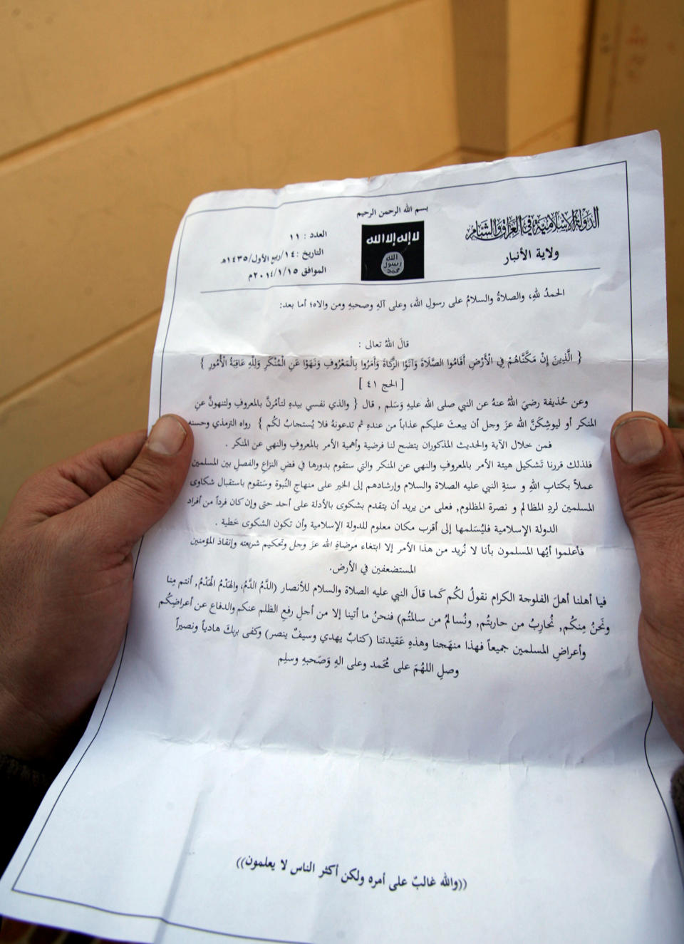 A man reads a pamphlet issued by al-Qaida-linked militants in Fallujah, Iraq, Thursday, Jan. 16, 2014. Members of al-Qaida's local franchise handed out pamphlets urging residents in the western city of Fallujah to take up arms and back the militants in their weeks-long fight against Iraqi troops as clashes raged on around the city, residents said Thursday. (AP Photo)