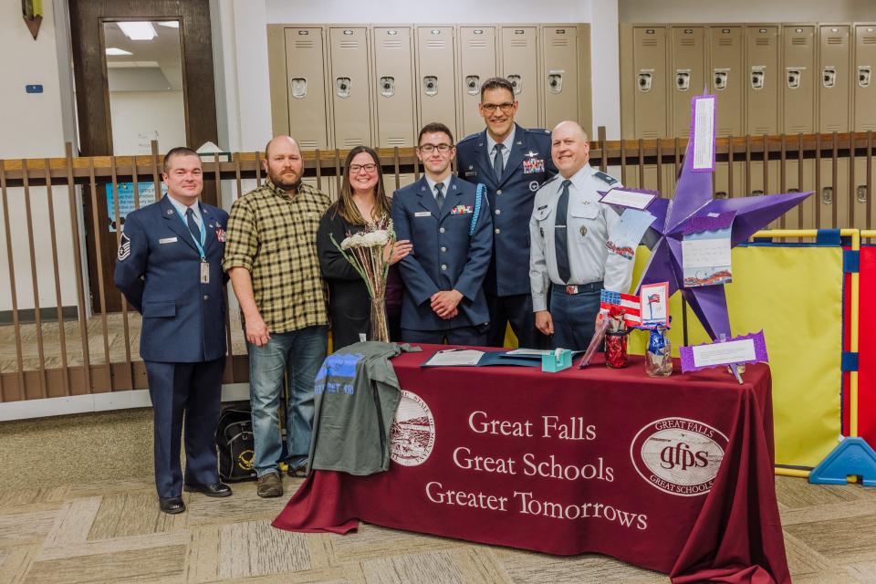 JROTC Cadet Corps Commander Nathaniel Mayer (center) of Great Falls High School was awarded a scholarship to Montana State University for his efforts in the program as part of the Purple Up Recognition Lunch honoring military families at the Early Learning Family Center Thursday.