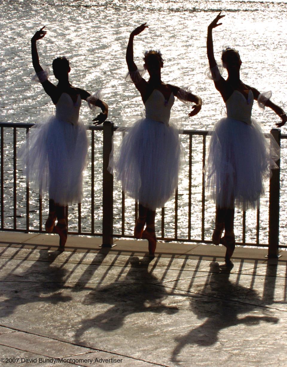 Alabama Dance Theatre dancers in silhouette against the Alabama River.