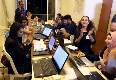 Beirut Madinati candidates and delegates cheer while monitoring ballot counts for the municipality elections after closing the polling stations during Beirut's municipal elections, Lebanon, May 8, 2016. REUTERS/Mohamed Azakir