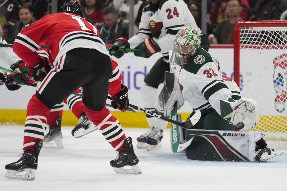 Minnesota Wild goaltender Filip Gustavsson makes a save against Chicago Blackhawks right wing Taylor Raddysh during the second period of an NHL hockey game, Wednesday, Feb. 7, 2024, in Chicago. (AP Photo/Erin Hooley)
