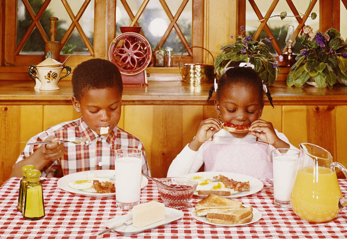 Two children eating breakfast