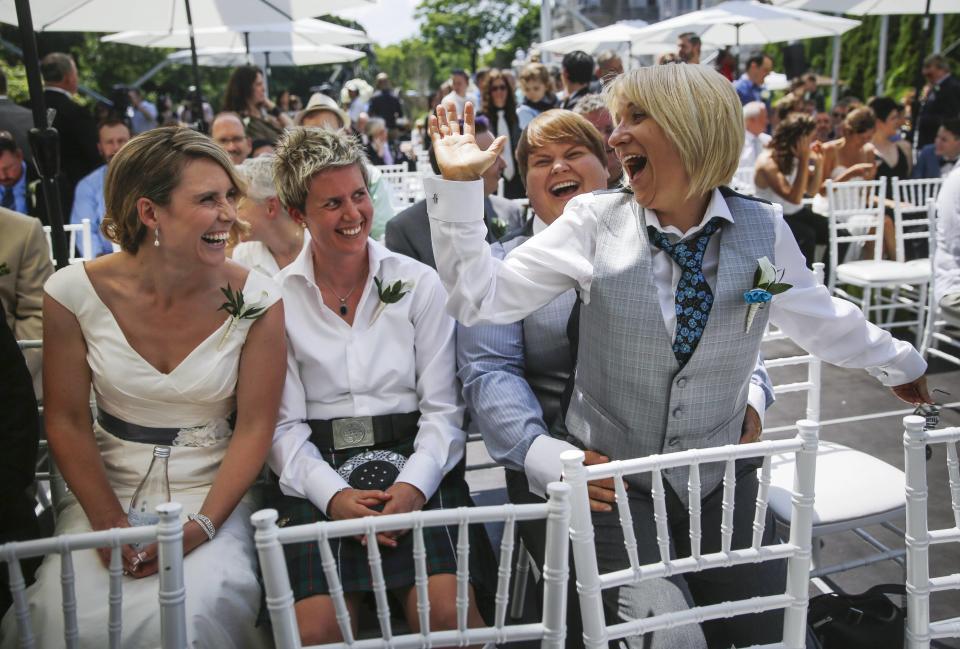 Couples celebrate before "The Celebration of Love", a grand wedding where over 100 LGBT couples got married, at Casa Loma in Toronto