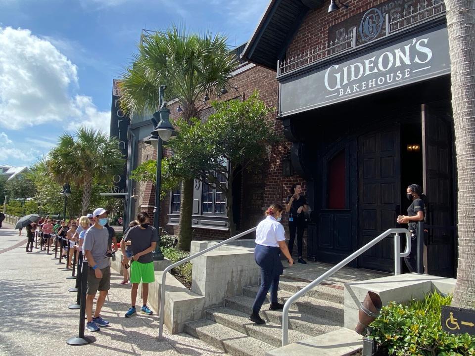 People wait outside Gideon's Bakehouse at Disney Springs.