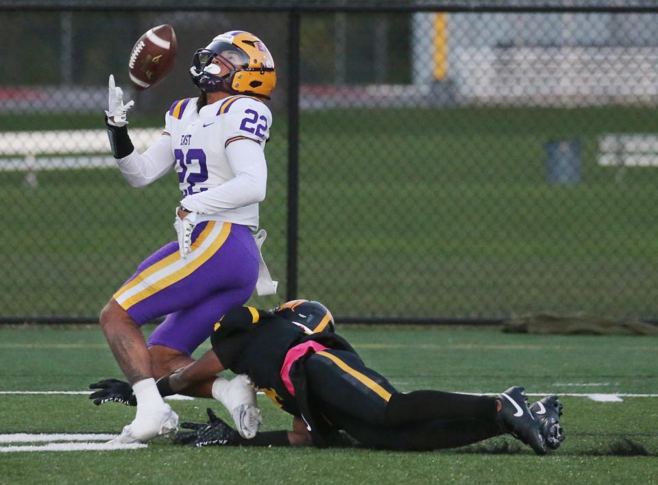 East wide receiver Anthony Diaz makes a one-handed, over-the-shoulder catch earlier this season against Greece Athena's Darius Howard for a big gain down the sideline.