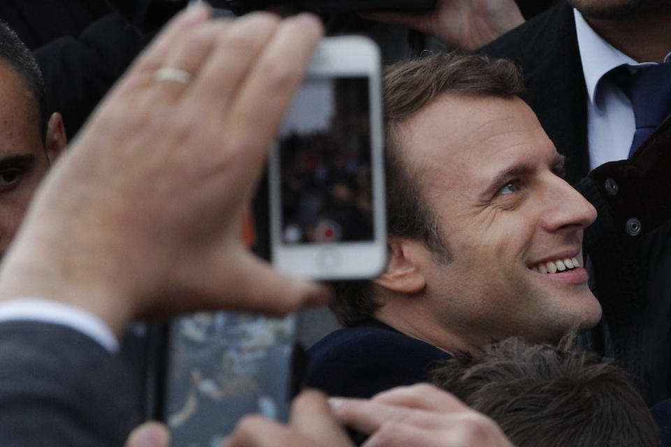 <p>French independent centrist presidential candidate Emmanuel Macron shakes hands with well-wishers as he leaves the polling station after casting his ballot in the presidential runoff election in Le Touquet, France, Sunday, May 7, 2017. (Christophe Ena/AP) </p>