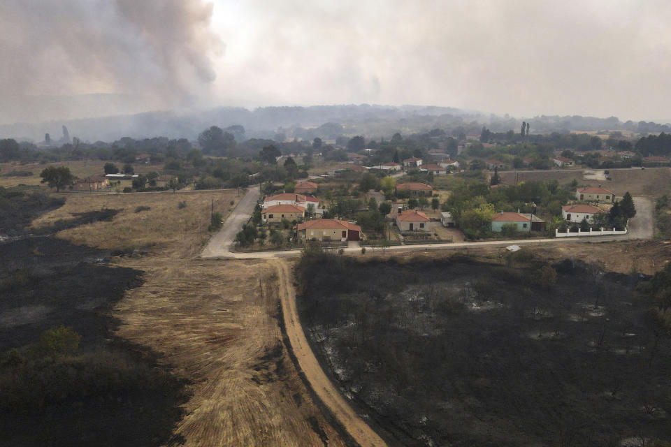 A wildfire burns in Giannouli village, in the northeastern Evros region, Greece, Thursday, Aug. 31, 2023. Greek authorities have further reinforced firefighting forces in the country's northeast, where a massive blaze in its thirteenth day has flared up once more, triggering authorities to issue alerts to residents in the area to be on standby for possible evacuation. (e-evros.gr via AP)