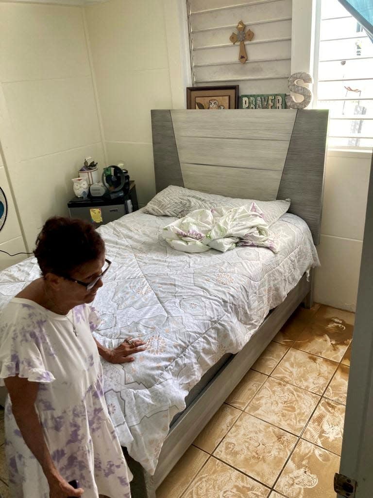 Maria de Jesus Medina, 83, stands in her home on Wednesday in the Ariel neighborhood of Comerío, Puerto Rico. Her apartment was flooded when rains from Hurricane Fiona caused the river and creek in her neighborhood to flood beyond its banks.