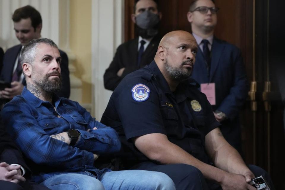 Former Washington Metropolitan Police Department officer Michael Fanone and U.S. Capitol Police Sgt. Harry Dunn listen as the House select committee investigating the Jan. 6 attack on the U.S. Capitol holds its final meeting on Capitol Hill in Washington, Monday, Dec. 19, 2022. (AP Photo/Jacquelyn Martin)