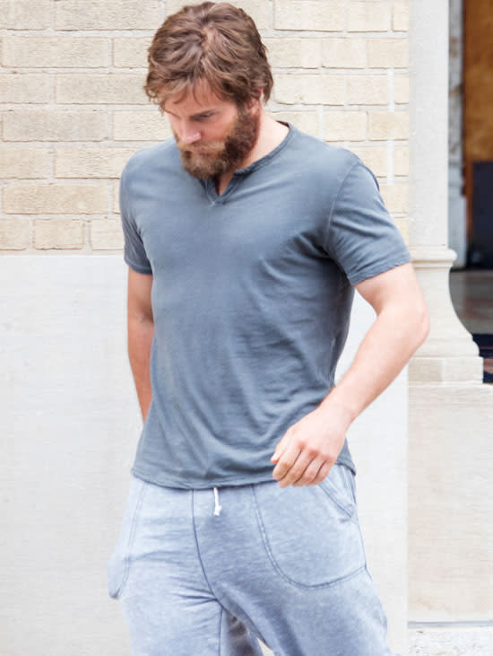 Chris Pratt has had a lot of different looks during his career – from chubby to skinny, from skinny to outrageously buff, and from clean to scruffy. But for his new role in the upcoming sci-fi drama <em>Passengers</em> he looks almost unrecognizable. At first glance, you can’t even tell who this bearded man is. AKM/GSI Look at that epic beard! It's hard to tell it's even Pratt and not a hermit from the mountains who hasn't been to the big city in 20 years. <strong>WATCH: Hollywood's 9 Hottest Hunks of Summer </strong> As ruggedly handsome as Pratt looks with his off the grid-style facial hair on the Atlanta, Georgia set of <em>Passengers</em>, thankfully the beard is fake. Just a few days before, Pratt was photographed on set totally clean shaven and flashing a peace sign like a stud. AKM/GSI Unless Pratt can grow a massive beard at will -- which we wouldn't put past him -- he is almost impossibly cool. Pratt stars opposite Jennifer Lawrence in the sci-fi romance <em>Passengers</em>, which tells the tale of a group of interstellar space travelers who are put in cryogenic sleep for a long trip across the stars. <strong>NEWS: Chris Pratt & Jennifer Lawrence's Sci-Fi Movie 'Passengers' Is Totally Happening! </strong> Pratt plays a passenger who wakes up early and must face the possibility of living for decades by himself before the ship reaches its destination. He decides to wake up another passenger (Lawrence) out of a desperate need for someone to interact with. <em>Passengers </em>is set for release in December 2016. For more on Chris Pratt and the many reasons why everyone loves him so much, check out the video below.