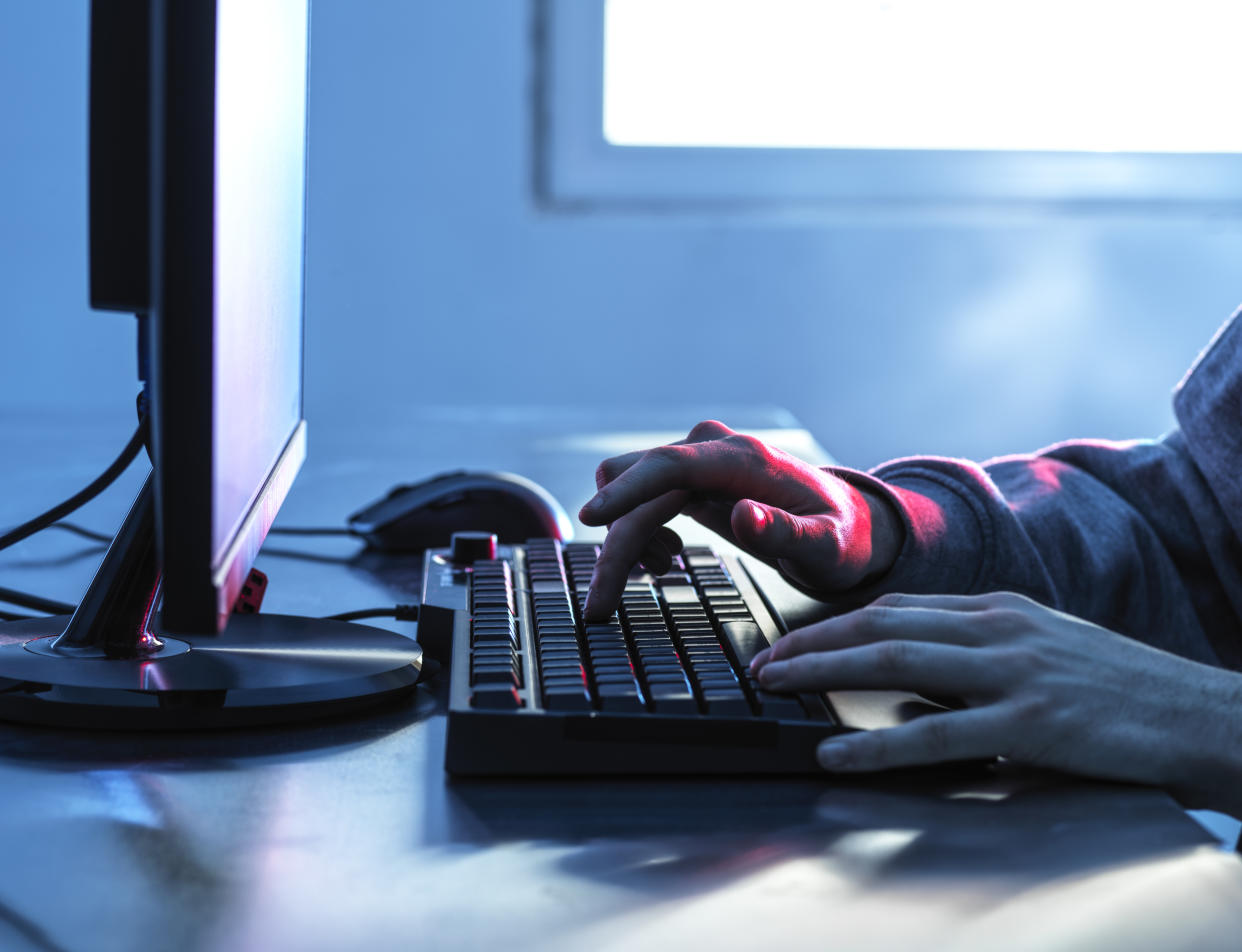 Woman's hands on computer indicating sexploitation