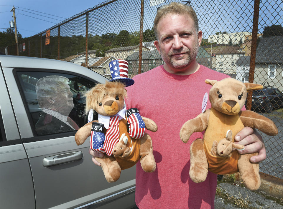Ben Philips shows off two of his Trump kangaroos outside his apartment in Bloomsburg, Pa., Wednesday, Sept. 19, 2020. Philips is one of the people who died of a medical emergency during the storming of the Capitol on Wednesday, Jan. 6, 2021. He was the founder of a pro-Trump social media site called Trumparoo and had coordinated transportation for several dozen people from Pennsylvania to Washington. (Keith Haupt/Bloomsburg Press Enterprise via AP)