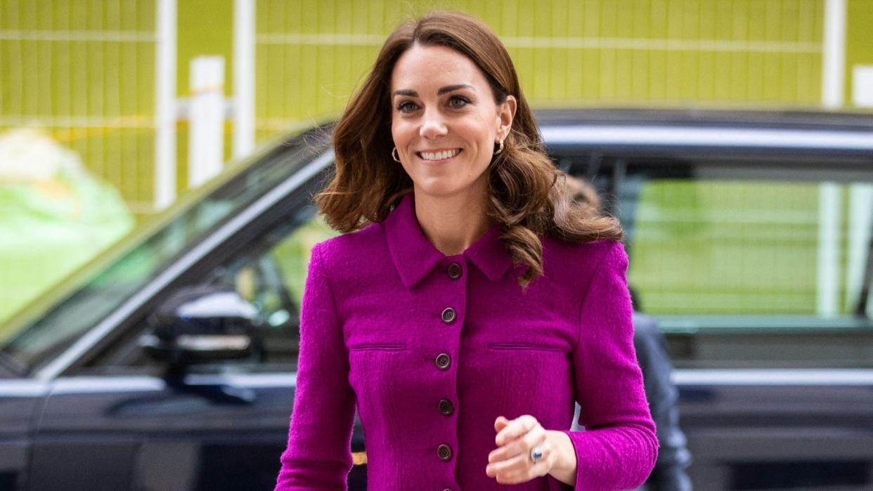 Kate Middleton in a magenta dress and black tights